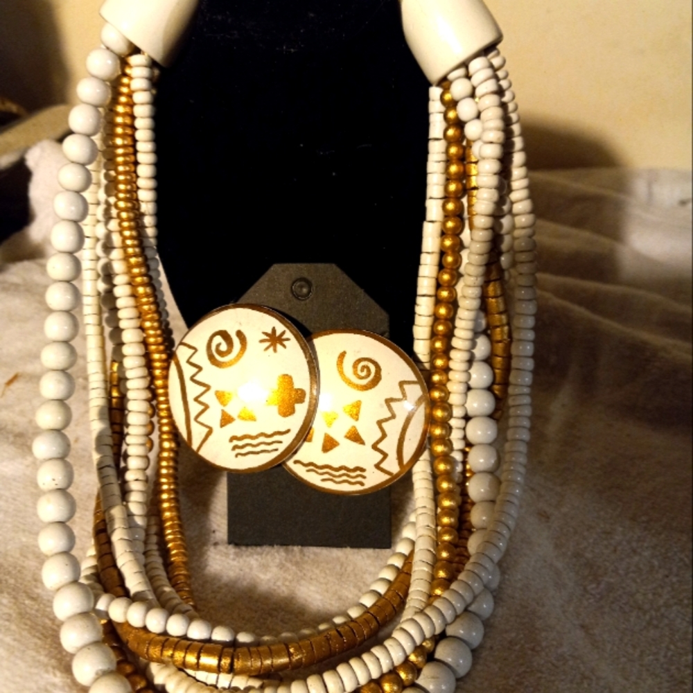Used,not new choker length wood bead necklace and matching clip on earrings.